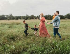 A nice picture of a traditional family walking through a meadow, to illustrate a blog post about being childfree in older age.