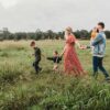 A nice picture of a traditional family walking through a meadow, to illustrate a blog post about being childfree in older age.